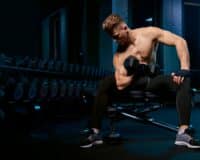 Muscular Sportsman Building Biceps With Dumbbell | Bodytech Supplements